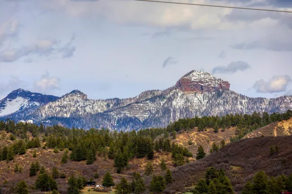 a view of a house with a mountain and mountains in the background
