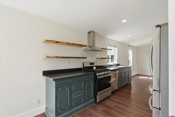 a kitchen with stainless steel appliances granite countertop a stove and a sink