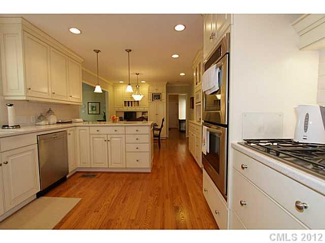 3100 High Ridge Road Charlotte, NC 28270 - Photo 5 of 16 a kitchen with stainless steel appliances granite countertop a stove a sink dishwasher and a refrigerator with wooden floor