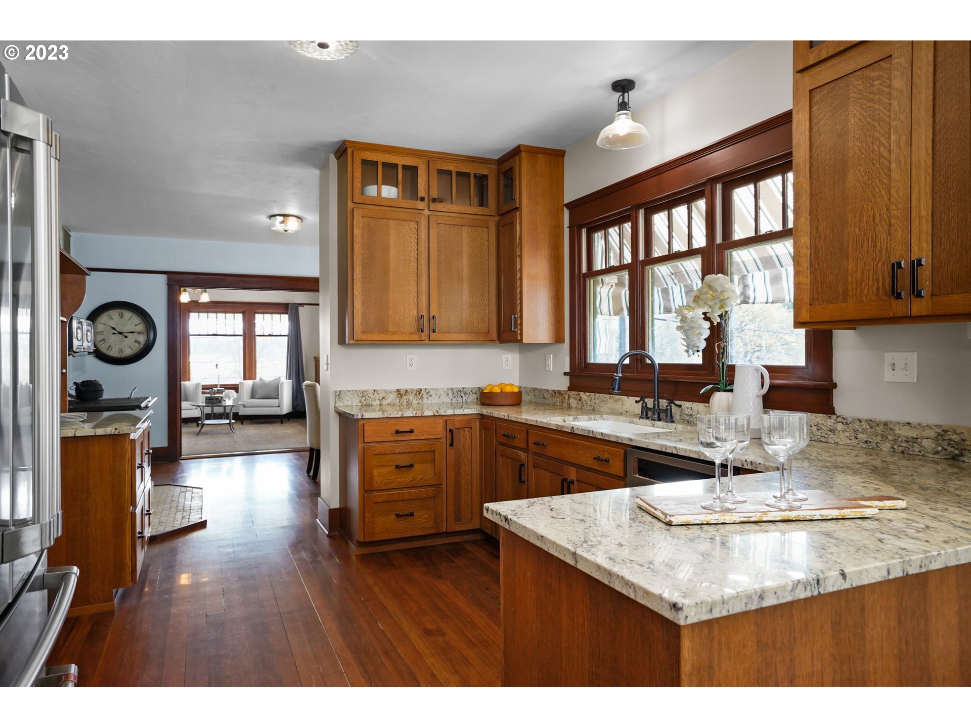 34466 Brewster Road Lebanon, OR 97355 - Photo 11 of 40 a kitchen with wooden cabinets a sink a window and stainless steel appliances