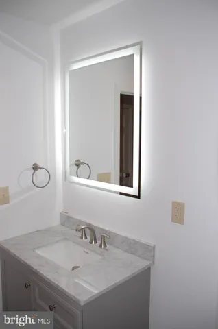 a bathroom with a sink vanity and a mirror