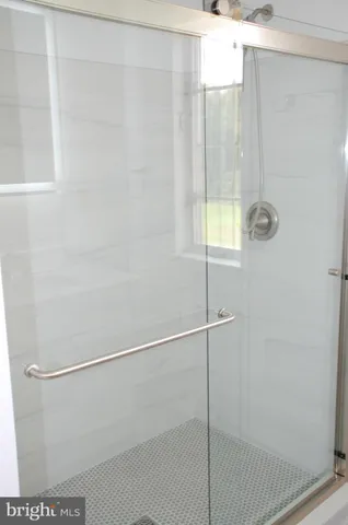 a bathroom with a glass shower door