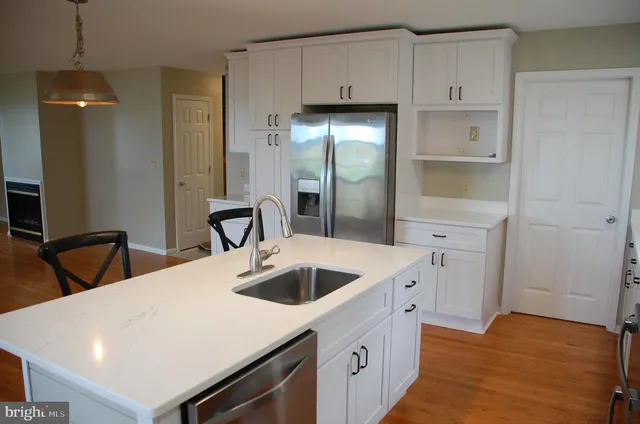 a kitchen with a sink and a refrigerator
