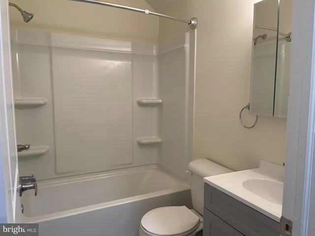 a bathroom with a toilet and a bathtub