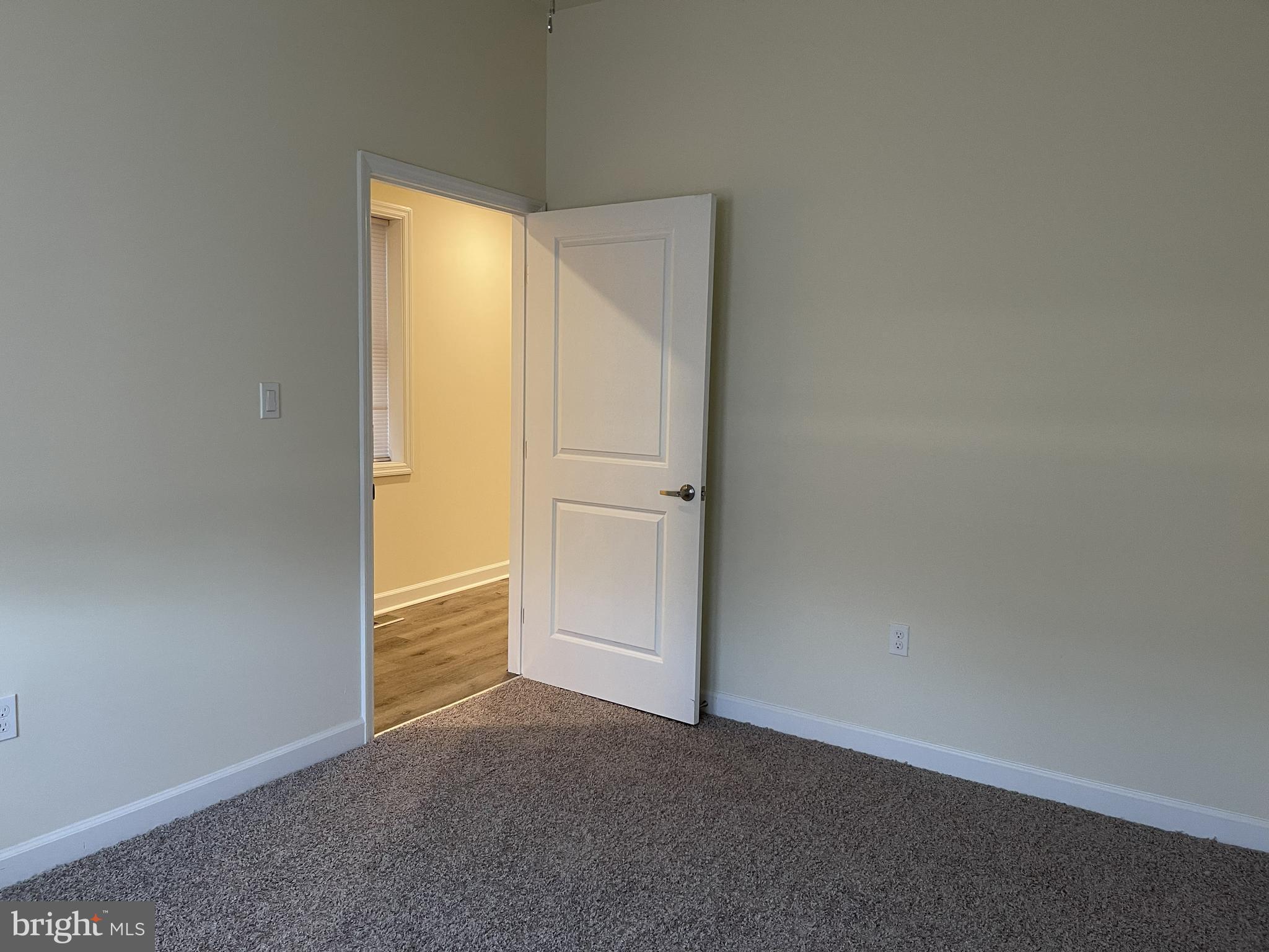 351-349 Oakwood Avenue, Unit 351A Glassboro, NJ 08028 - Photo 4 of 4 an empty room with an empty space and a window