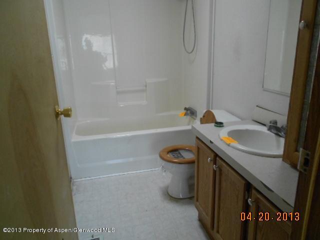 141 Daniel Avenue Rifle, CO 81650 - Photo 11 of 13 a bathroom with a sink a toilet and bathtub
