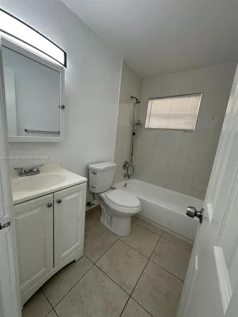 a bathroom with a toilet a sink and bathtub
