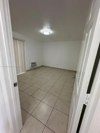 a view of a livingroom with kitchen and furniture