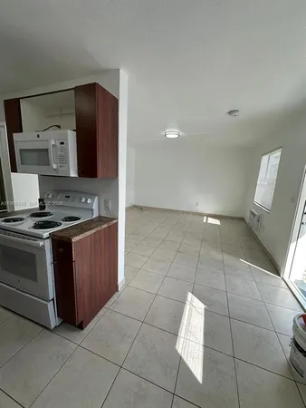 a kitchen with stainless steel appliances granite countertop a sink and a stove