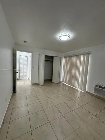 a view of an empty room and a window