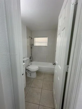 a bathroom with a sink a toilet and tub