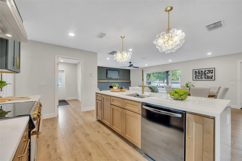 350 Cornwall Road Winter Park, FL 32792 - Photo 16 of 36 a kitchen with a stove a counter space a sink and chandelier