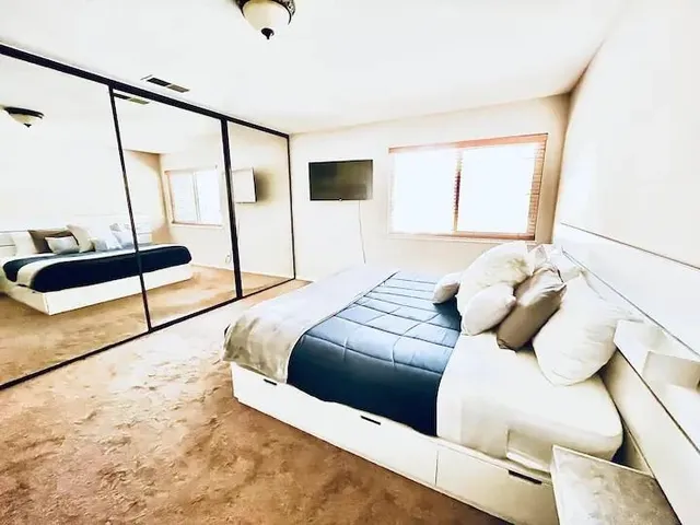 a bedroom with a bed and wooden floor