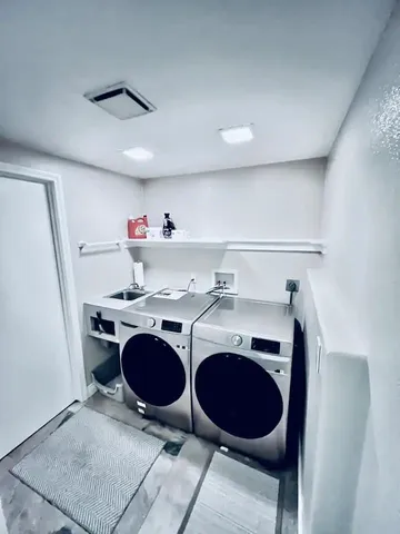 a view of cabinets a washer and dryer