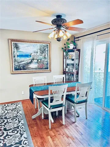 a view of a dining room with furniture wooden floor and a chandelier