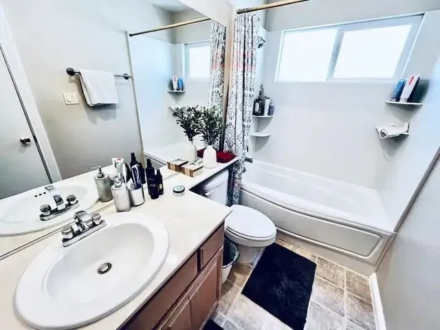a bathroom with a sink toilet and shower