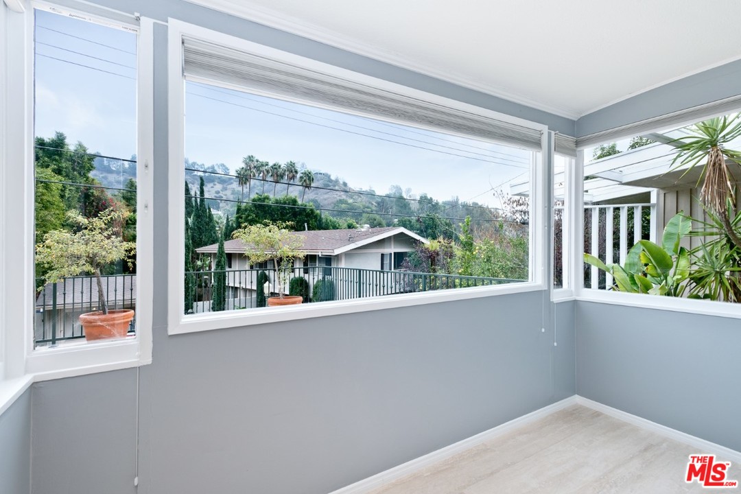 9614 Heather Road Beverly Hills, CA 90210 - Photo 14 of 25 a view of a house with a porch and a floor to ceiling window