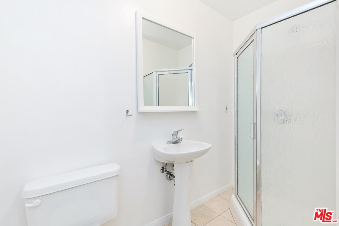 9614 Heather Road Beverly Hills, CA 90210 - Photo 17 of 25 a bathroom with a sink a toilet and shower