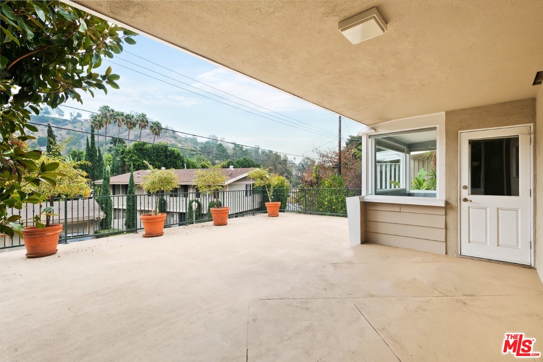 9614 Heather Road Beverly Hills, CA 90210 - Photo 24 of 25 a view of a terrace with seating space