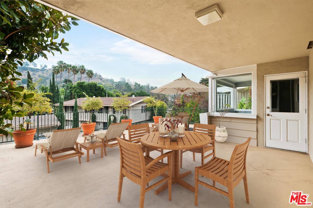 9614 Heather Road Beverly Hills, CA 90210 - Photo 5 of 25 a view of a patio with a table and chairs