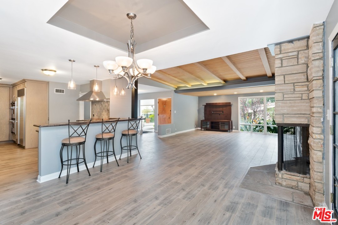 9614 Heather Road Beverly Hills, CA 90210 - Photo 6 of 25 a view of a dining room with furniture and wooden floor