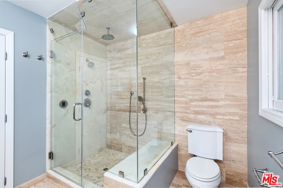 9614 Heather Road Beverly Hills, CA 90210 - Photo 9 of 25 a bathroom with a toilet and shower