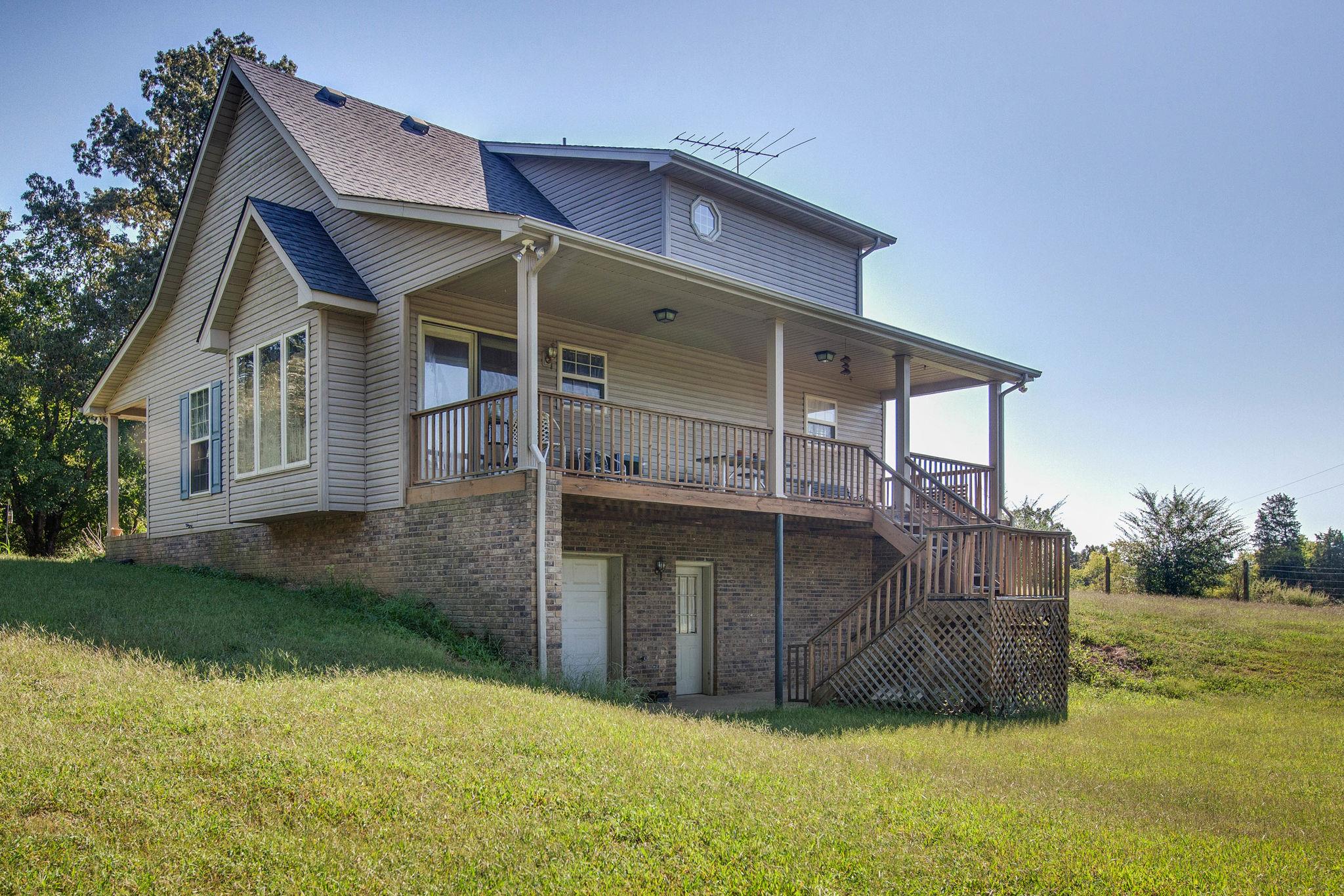 8120 Primm Springs Road Primm Springs, TN 38476 - Photo 24 of 27 a view of a house with brick walls and a yard