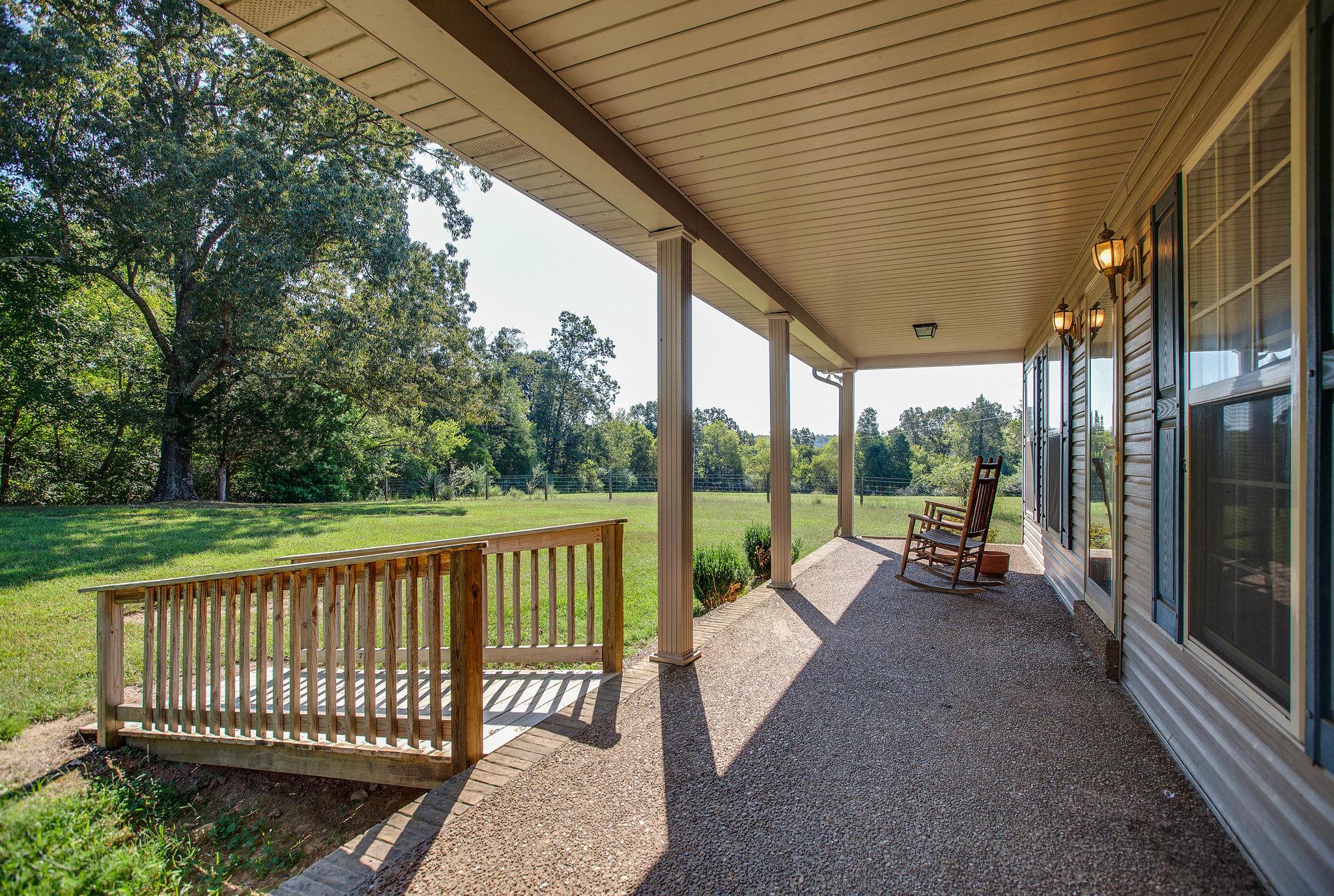 8120 Primm Springs Road Primm Springs, TN 38476 - Photo 4 of 27 a view of a porch with furniture and garden