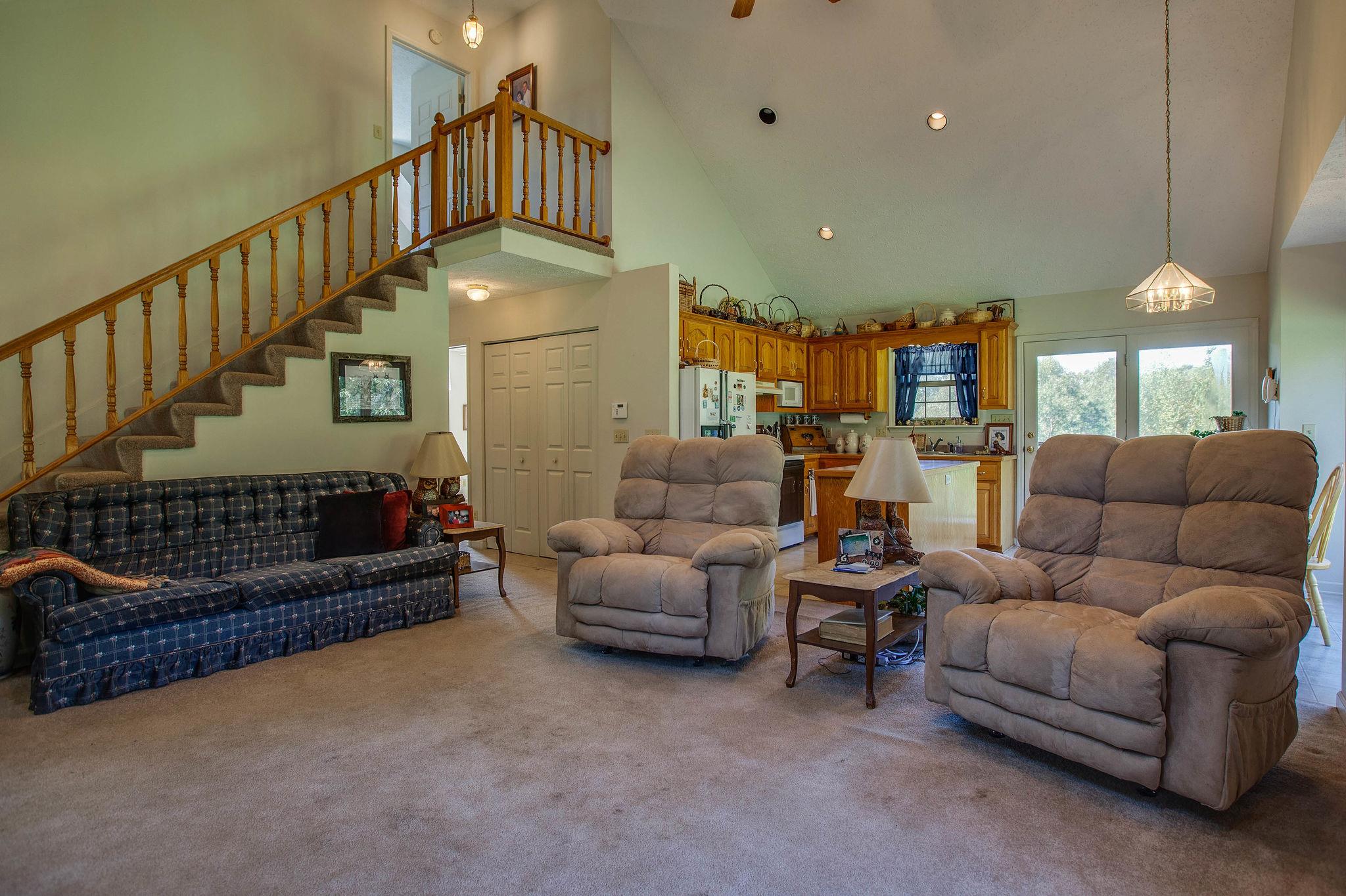 8120 Primm Springs Road Primm Springs, TN 38476 - Photo 6 of 27 a living room with furniture ceiling fan and a rug