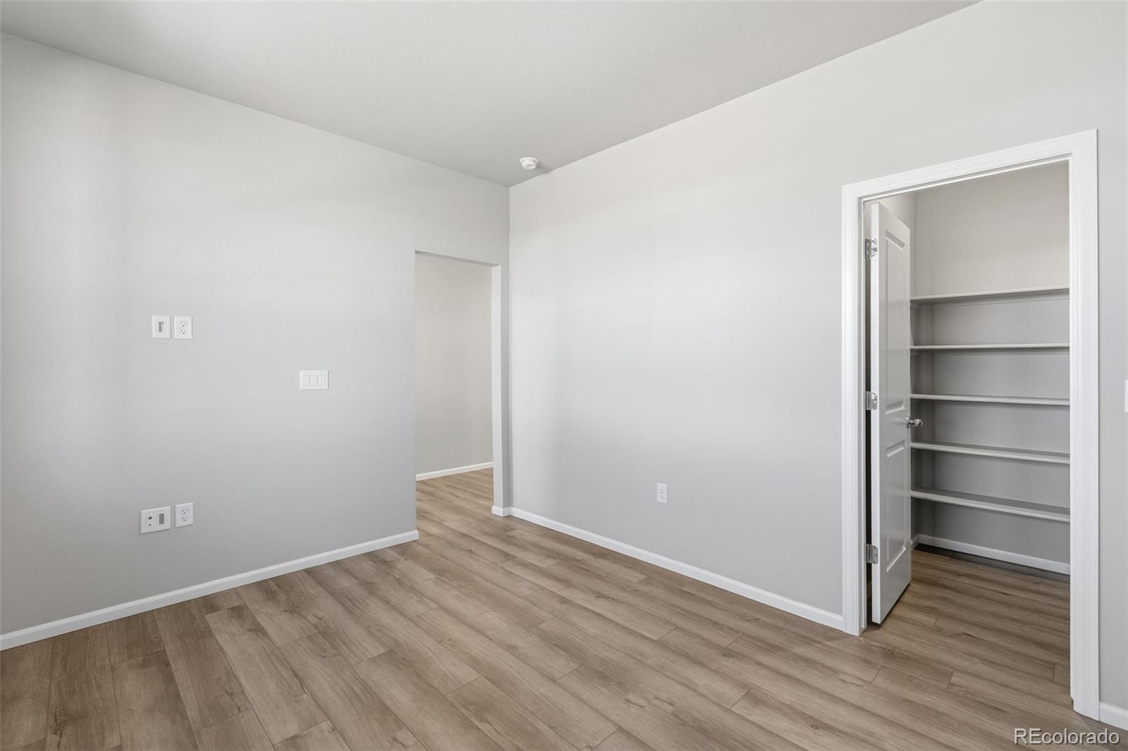 15293 Olive Way Thornton, CO 80602 - Photo 11 of 29 a view of an empty room with wooden floor