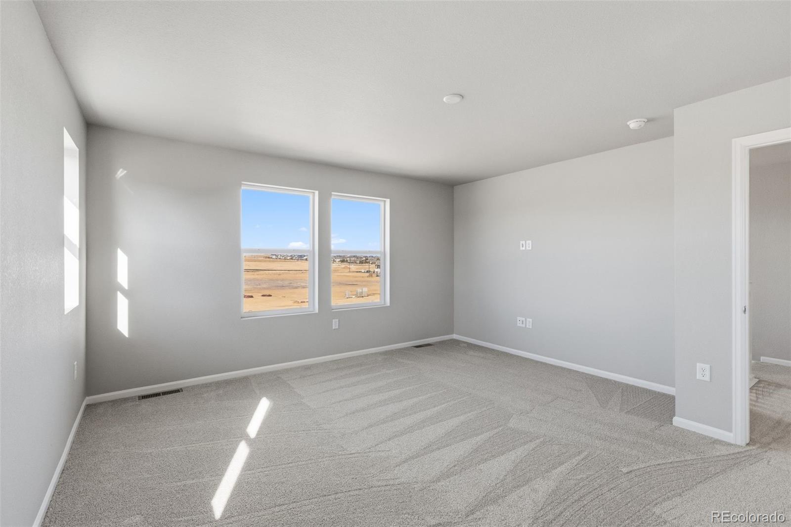 15293 Olive Way Thornton, CO 80602 - Photo 14 of 29 a view of an empty room with a window