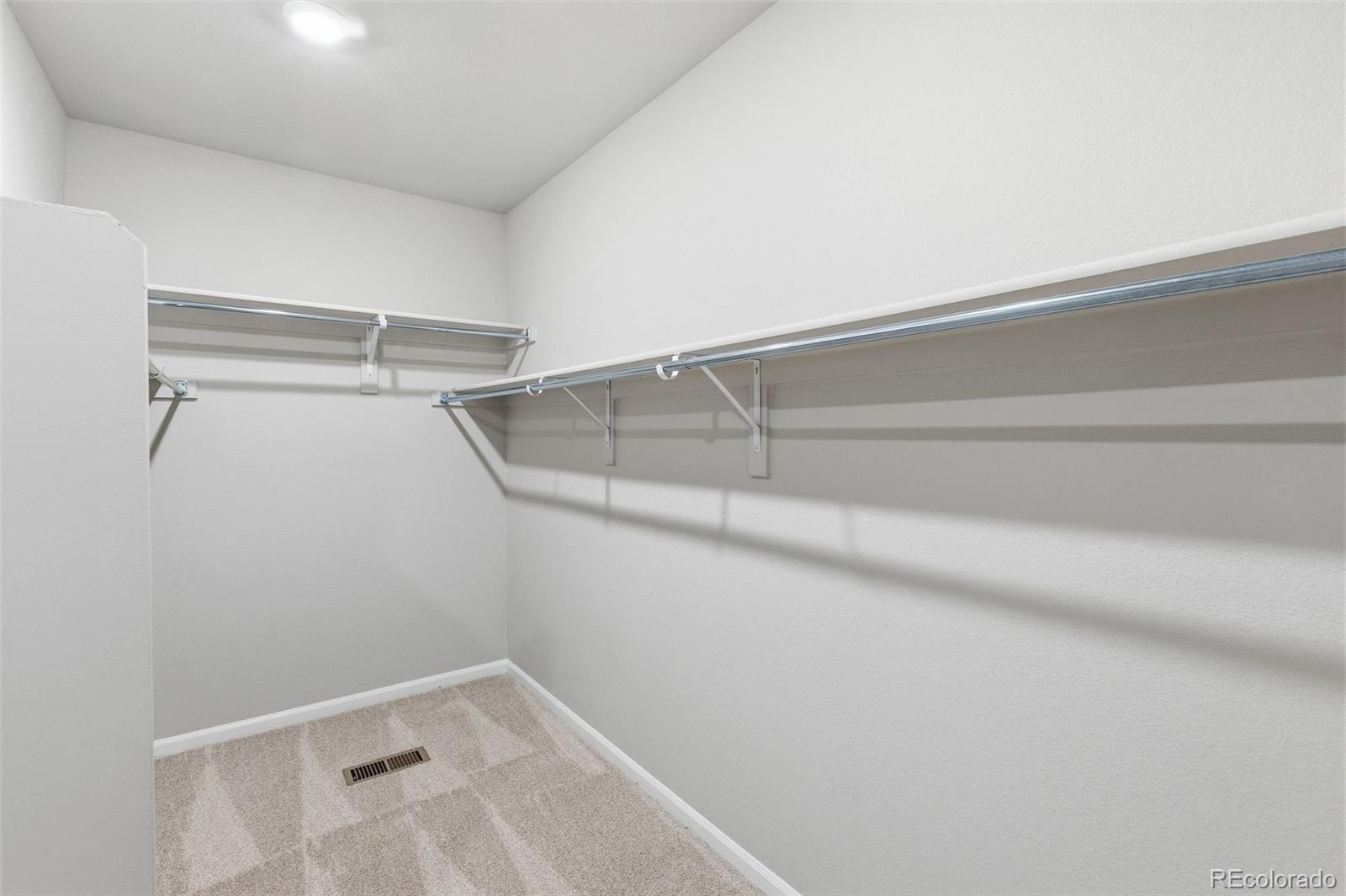 15293 Olive Way Thornton, CO 80602 - Photo 19 of 29 a view of a room with racks on the wall