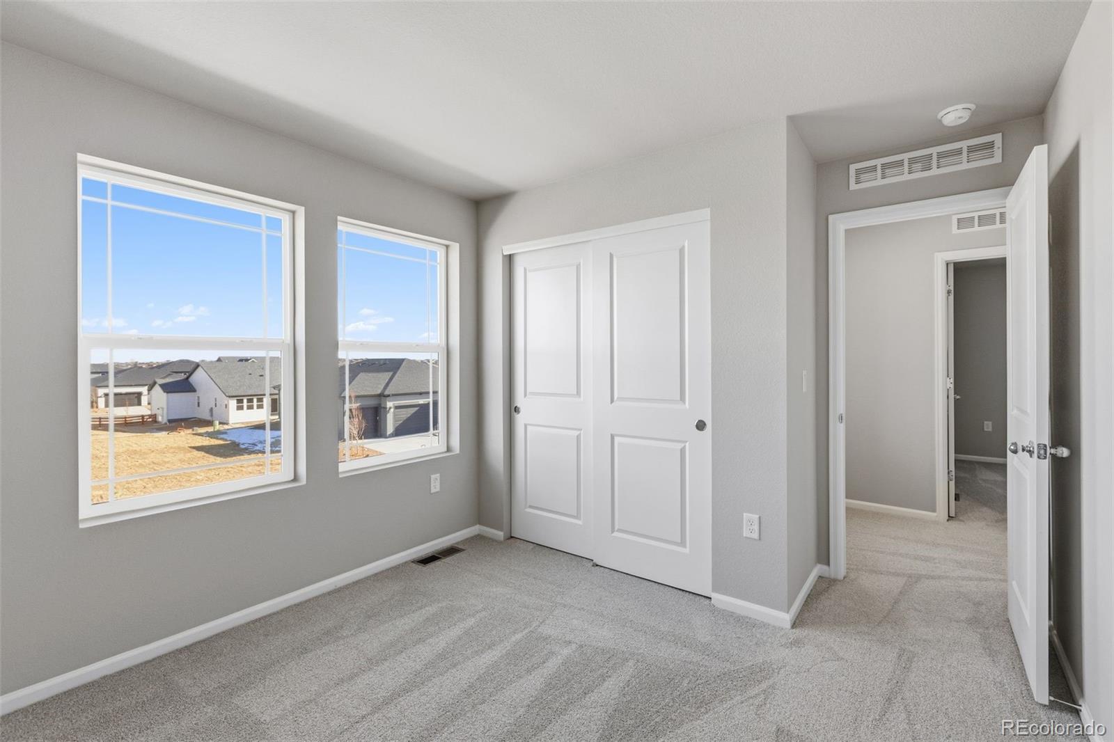 15293 Olive Way Thornton, CO 80602 - Photo 21 of 29 a view of an empty room with a window