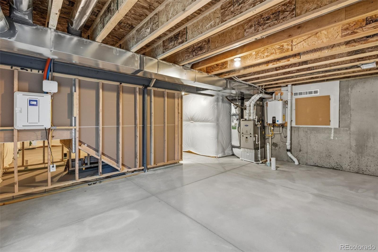 15293 Olive Way Thornton, CO 80602 - Photo 25 of 29 a view of an empty room with wooden walls
