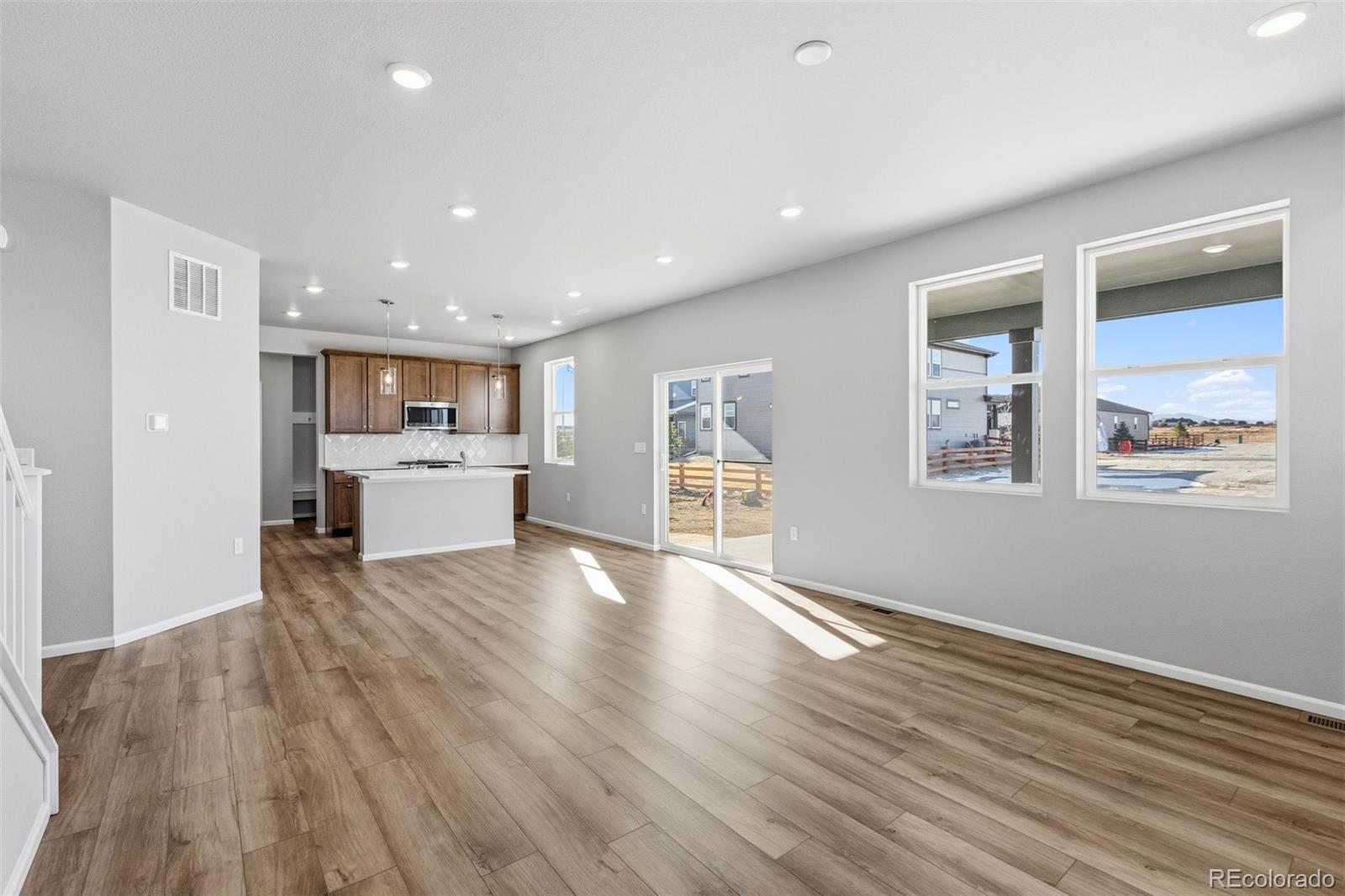15293 Olive Way Thornton, CO 80602 - Photo 9 of 29 a view of kitchen with cabinets and wooden floor