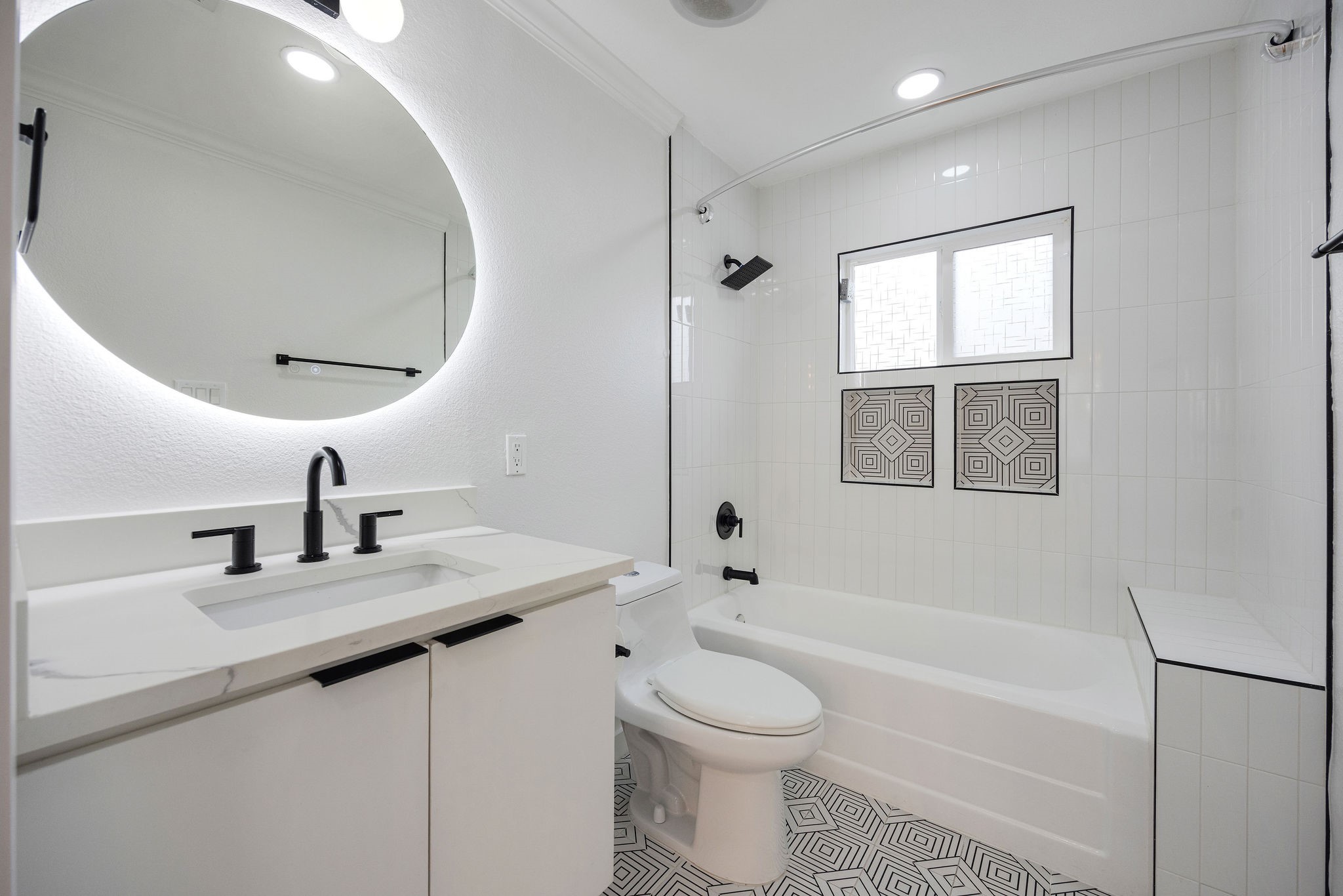 1310 Walton Street Houston, TX 77009 - Photo 14 of 19 Updated secondary bathroom with modern vanity, designer tile, and shower/tub combo.