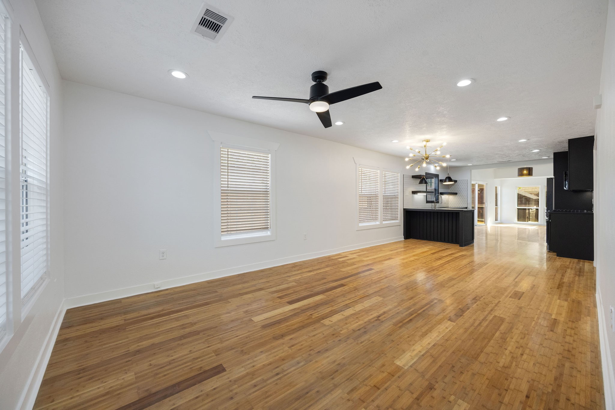 1310 Walton Street Houston, TX 77009 - Photo 4 of 19 Expansive open-concept living area with abundant natural light and hardwood flooring throughout.