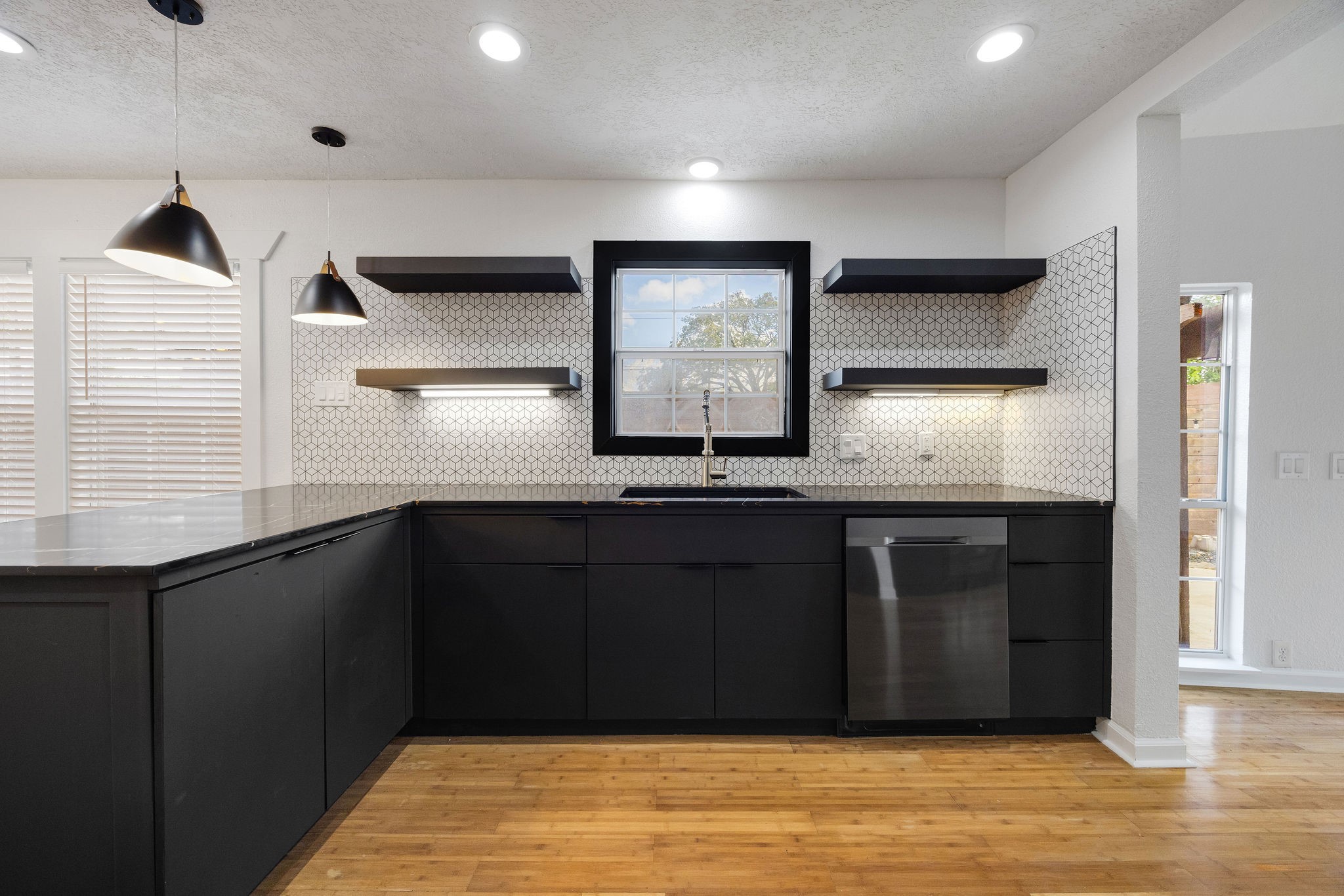 1310 Walton Street Houston, TX 77009 - Photo 6 of 19 Chef-inspired kitchen featuring quartz countertops, stainless steel appliances, and ample storage.