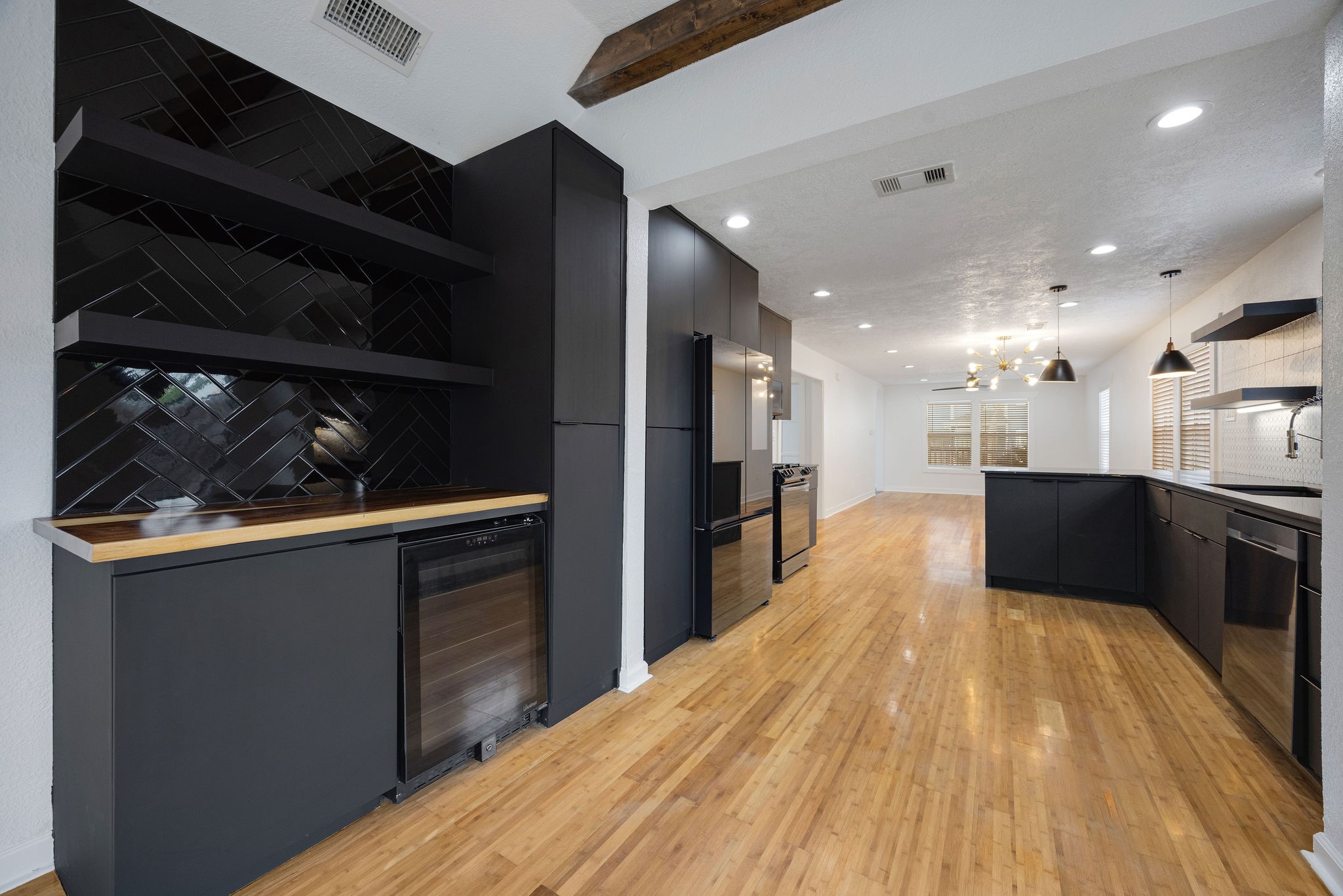 1310 Walton Street Houston, TX 77009 - Photo 9 of 19 Another view of the kitchen showcasing a great flow between the bar area, sleek appliances, and the open living space.