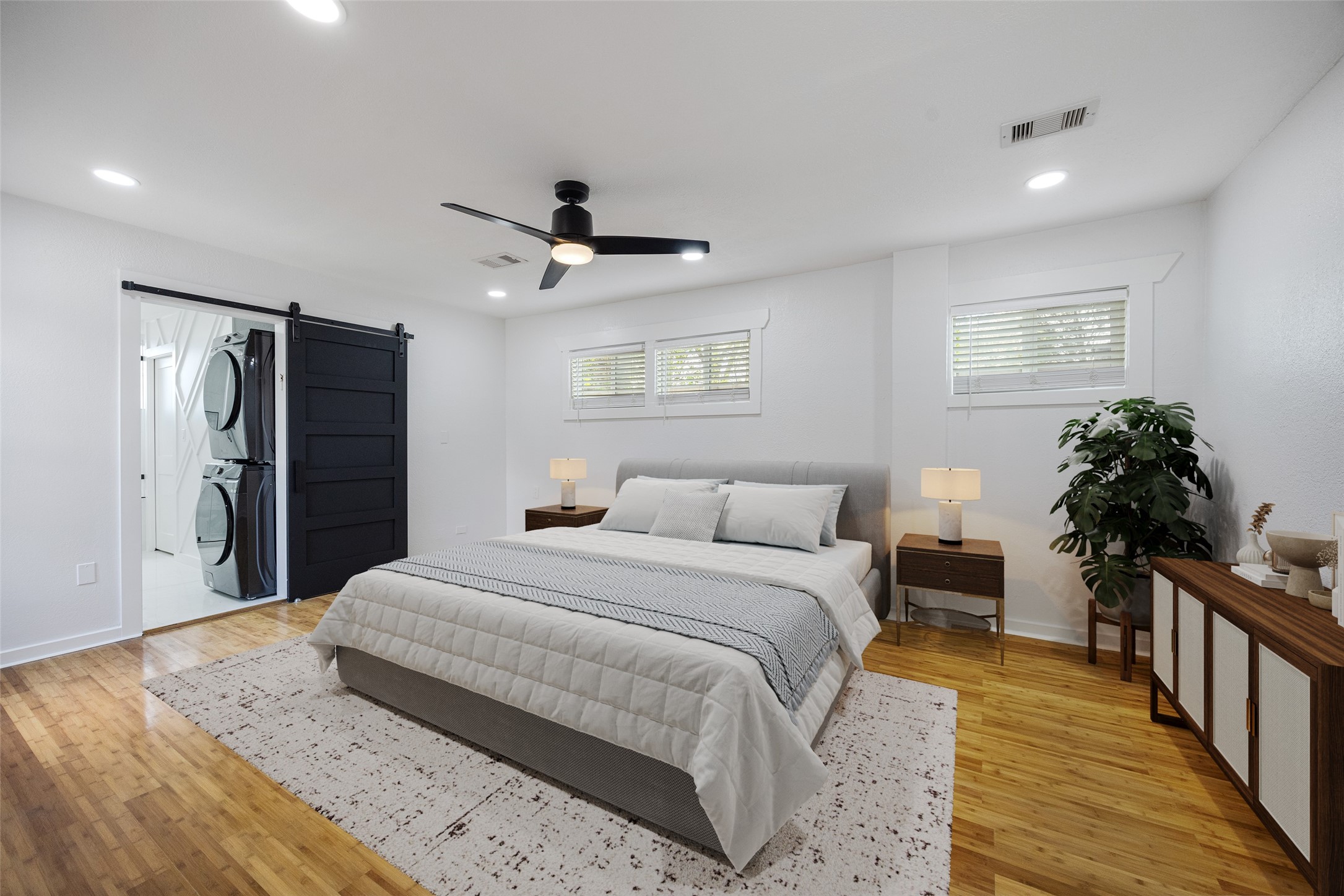 1310 Walton Street Houston, TX 77009 - Photo 10 of 19 a bedroom with a bed and a chandelier