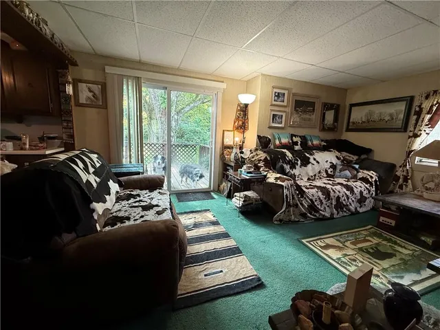 a bedroom with furniture and a large window