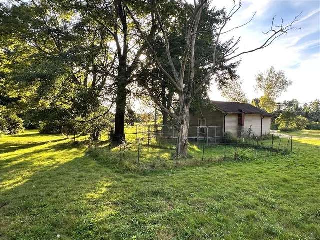 a backyard of a house with lots of green space