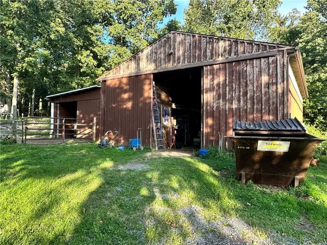 a view of a back yard of the house with a car park