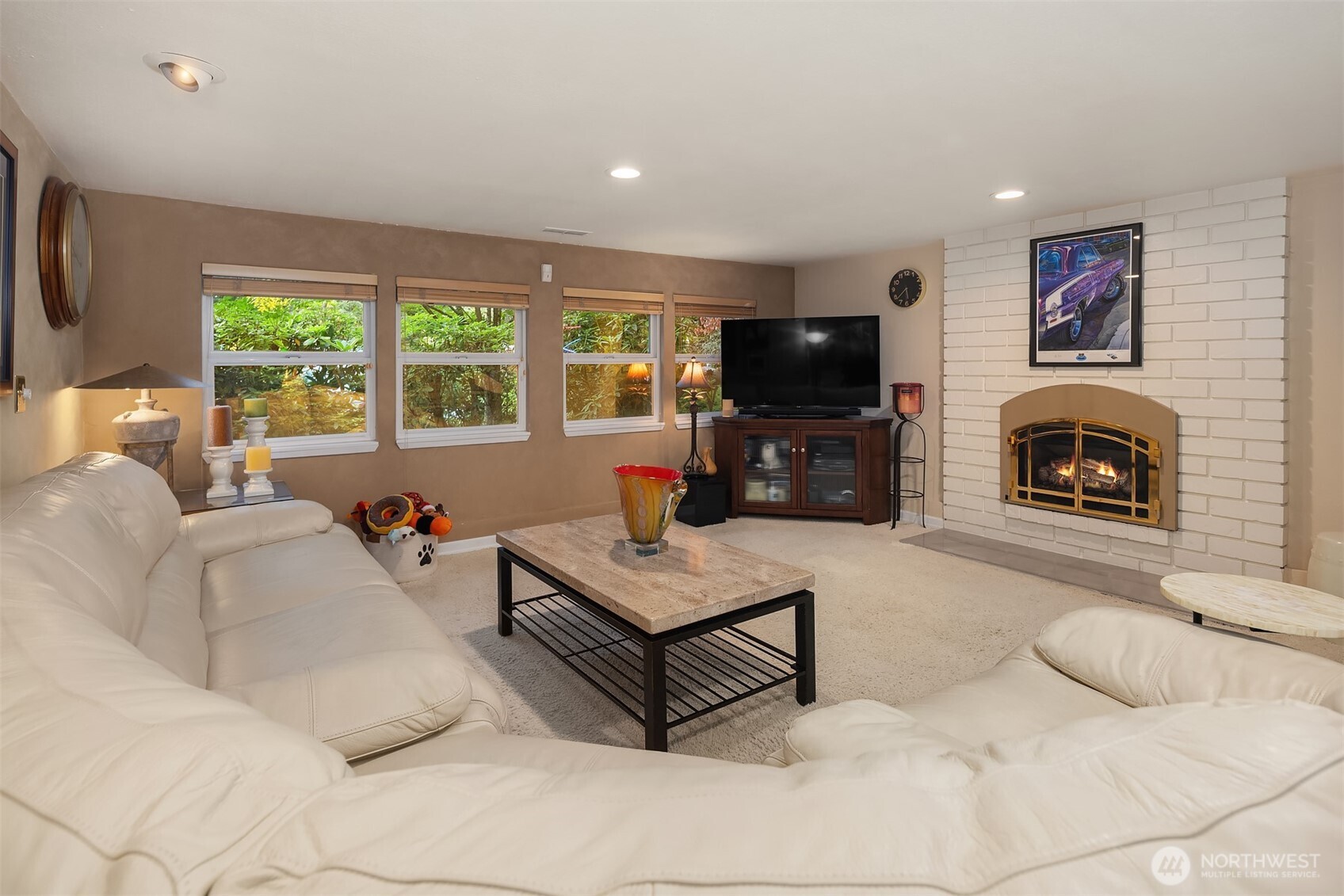 1616 175th Place Southeast Bothell, WA 98012 - Photo 16 of 37 a living room with furniture a flat screen tv and a fireplace