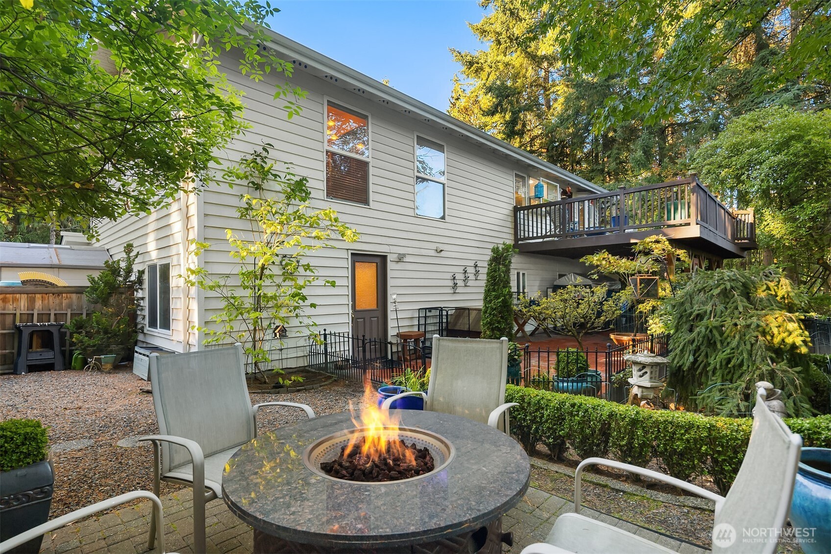 1616 175th Place Southeast Bothell, WA 98012 - Photo 21 of 37 a view of a patio with table and chairs potted plants and a large tree