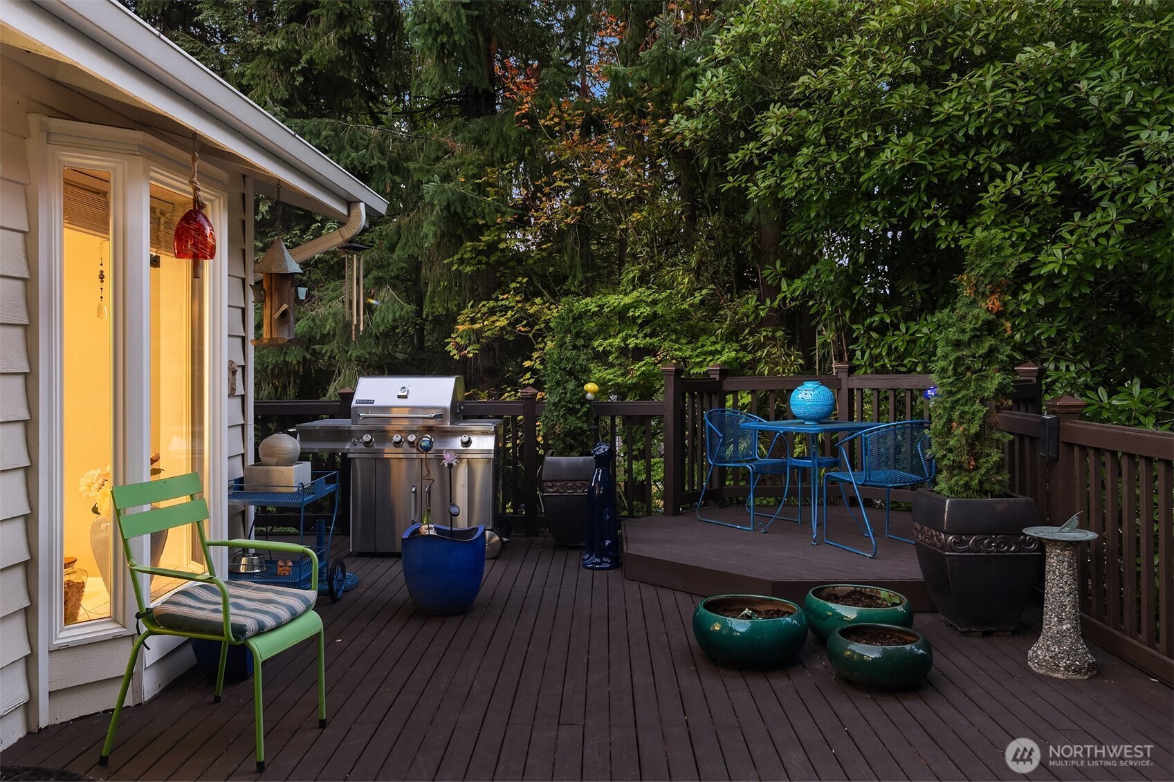1616 175th Place Southeast Bothell, WA 98012 - Photo 30 of 37 a view of a patio with table and chairs potted plants and floor to ceiling window