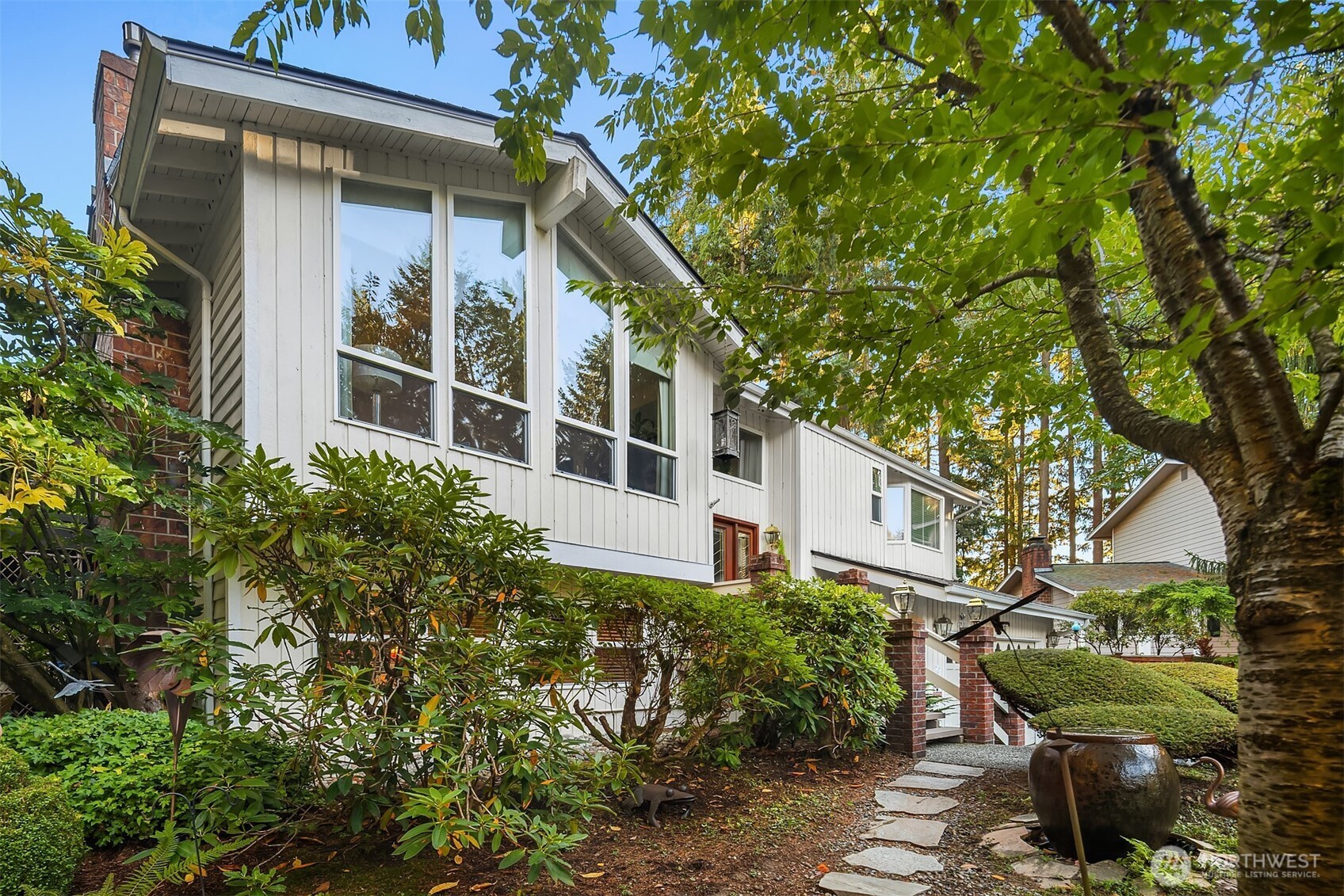 1616 175th Place Southeast Bothell, WA 98012 - Photo 35 of 37 a view of a house with a large windows and flower plants