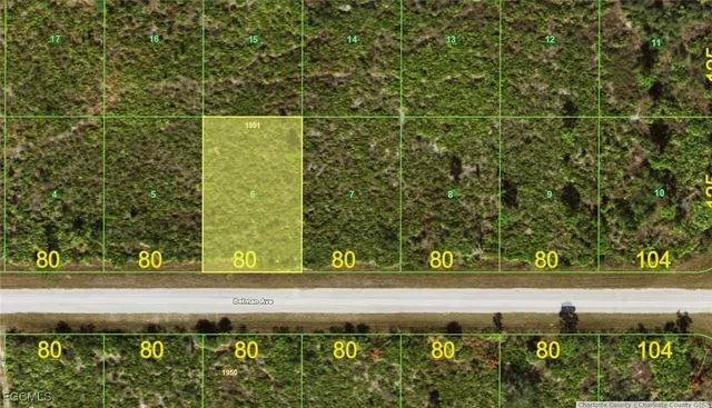 a view of a yard with wooden fence