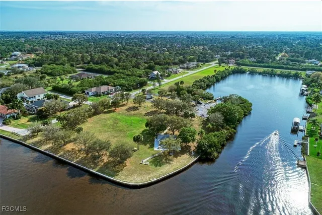 an aerial view of residential houses with outdoor space and lake view