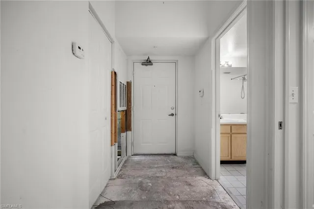 a view of a hallway with wooden shelves